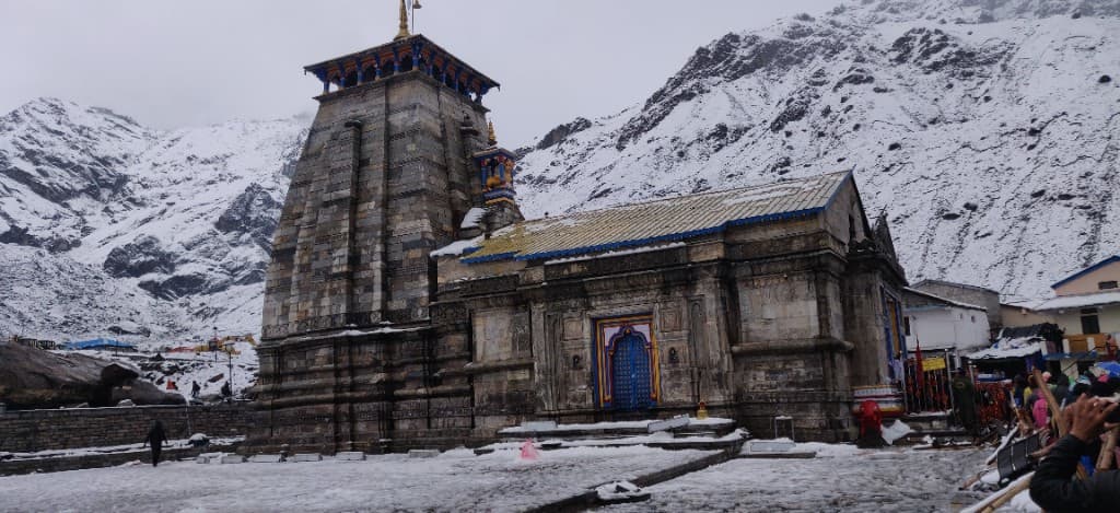 Kedarnath Temple surrounded by snow-covered mountains